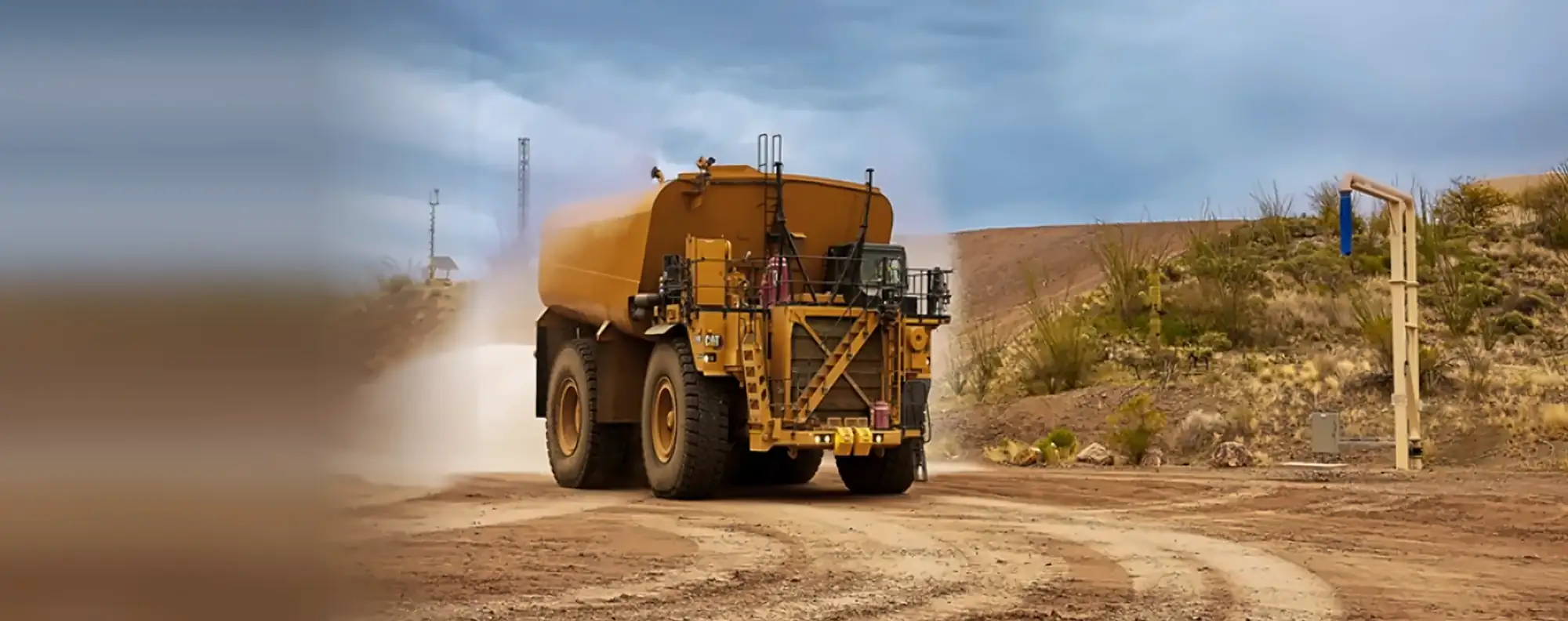 Water truck spraying a mine haul road to keep dust down